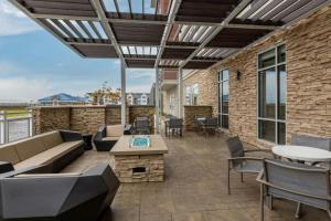 a patio with a couch and tables and chairs at SpringHill Suites by Marriott Columbus West in Columbus