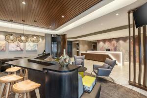 a living room with a bar and chairs at SpringHill Suites by Marriott Columbus West in Columbus