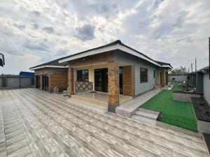 a house with a large patio in front of it at Pamusha Motel in Ngesi