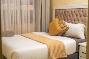 a hotel room with two beds with pillows at Pamusha Motel in Ngesi