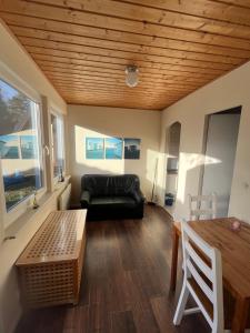 a living room with a couch and a table at Bungalow Beate in Zinnowitz