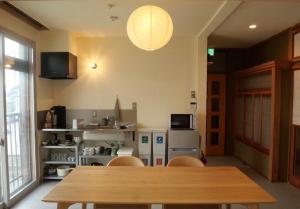 a dining room with a wooden table and chairs at HITOYANE guesthouse-1日1組限定- in Aizuwakamatsu