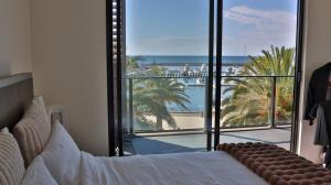 a bedroom with a bed and a view of the ocean at Beach paradise in Werribee South