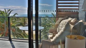 a room with a view of the ocean from a balcony at Beach paradise in Werribee South