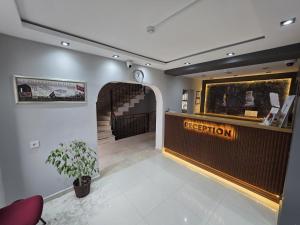 a hotel lobby with a reception desk and a staircase at Gizem Pansiyon in Çanakkale