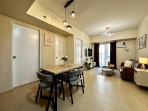 a dining room and living room with a table and chairs at 2-Bedroom Condo Unit with Balcony at Centrio Tower beside Ayala Centrio Mall Downtown CDO in Cagayan de Oro
