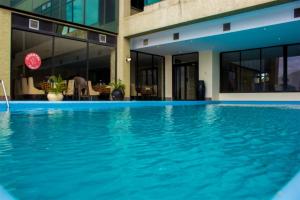 a swimming pool in front of a building at Seashells Millennium Hotel in Dar es Salaam