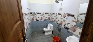 a bathroom with a toilet and a sink at K Apartment in Varkala