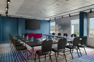 a conference room with a long table and chairs at Aloft by Marriott Houston by the Galleria in Houston