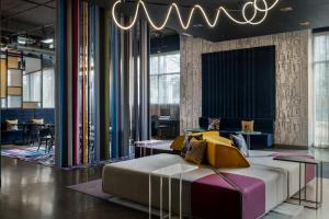 a bedroom with a bed and a chandelier at Aloft by Marriott Houston by the Galleria in Houston +30 photos