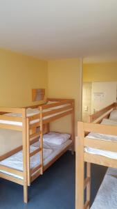 a room with three bunk beds in it at Jugendherberge-Berlin-International in Berlin