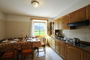 a kitchen with a table with chairs and a window at Stella Alpina - Happy Rentals in Livigno