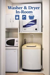 a kitchen with a microwave and a trash can at Box Hill Studio Apartment 2 in Box Hill