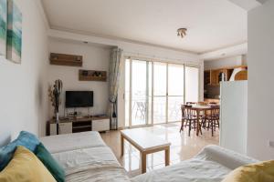 a living room with a couch and a table at SeaFront Apartment Marsascala in Marsaskala