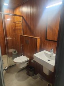 a bathroom with a toilet and a sink at HOTEL N K RESIDENCY in Guwahati +22 photos