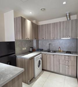 a kitchen with a washing machine and a washer at Republic square LUXURY with balcony in Yerevan