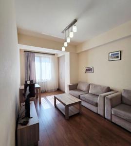 a living room with a couch and a table at Republic square LUXURY with balcony in Yerevan