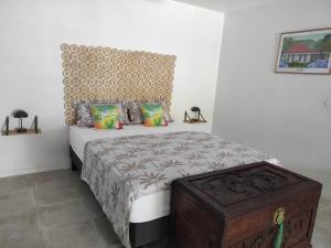 a bedroom with a bed with a wooden headboard at La Palmeraie Créole in Sainte-Marie +8 photos