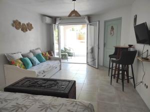 a living room with a couch and a table at La Palmeraie Créole in Sainte-Marie