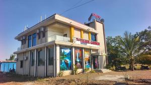 a building with a store in front of it at Hotel Visava Restaurant & Lodging in Vaghunde Budrukh