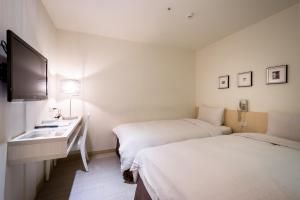 Voodi või voodid majutusasutuse Wemeet Hotel Taipei toas