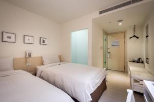 Voodi või voodid majutusasutuse Wemeet Hotel Taipei toas
