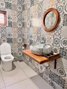 a bathroom with a sink and a toilet at Vrindavan homestay in Munroe Island +62 photos