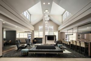 a large living room with a couch and a fireplace at Residence Inn by Marriott Springfield Chicopee in Chicopee