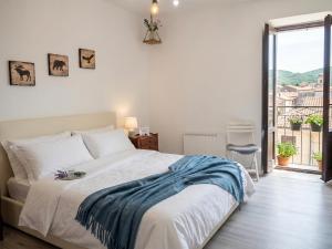 a bedroom with a bed and a large window at La Chiave del Gufo - Bojano in Boiano