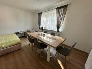 a dining room with a table and chairs and a bed at Waldhaus in Affing