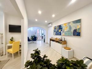 a kitchen and living room with a large painting on the wall at Syrene Suites Sorrento in Piano di Sorrento