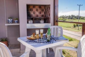 a white table with drinks and food on a porch at Radazul Apart de Mar & Campo in Chapadmalal