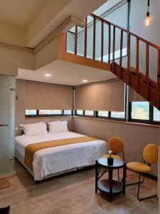 a bedroom with a bed and a staircase at Xianwang Homestay in Jincheng