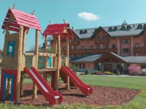 a playground with a slide in front of a building at Gaarten Hotel Benessere Spa by Kleos Group Collection in Gallio