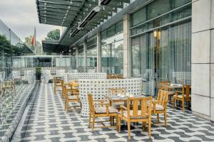 a restaurant with wooden tables and chairs on a patio at Bogotá Marriott Hotel in Bogotá