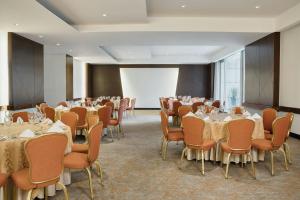 a conference room with tables and chairs and a projection screen at Bogotá Marriott Hotel in Bogotá +178 photos