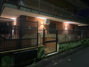 a fence in front of a building at night at Angel house airport in CTA
