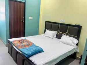 a bedroom with a bed with white sheets and pillows at Virasat Guest House in Lucknow