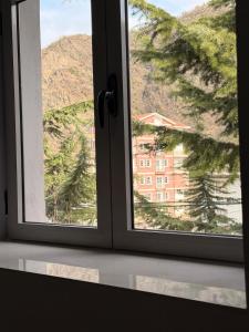 a window with a view of a building at The Green Loft in Fushë-Arrëz +7 photos
