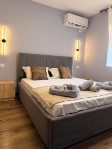 a large bed with two pillows on it in a bedroom at The Green Loft in Fushë-Arrëz