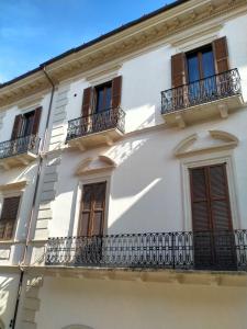 a white building with windows and balconies at ANTONELLI Apartment L'AQUILA in LʼAquila