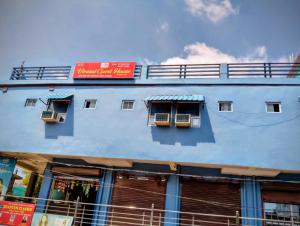 a blue building with windows on the side of it at Virasat Guest House in Lucknow