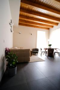 a living room with a couch and a table at The Tower Premium Apartment - Beams & Views - 3 Min Walk to Bernina Express & Station in Tirano