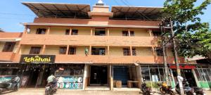a building on a street with motorcycles parked in front of it at K Apartment in Varkala
