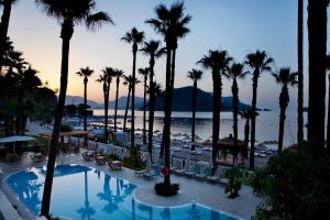 a view of a resort with palm trees and a pool at Quadas Hotel - Adult Only in Marmaris
