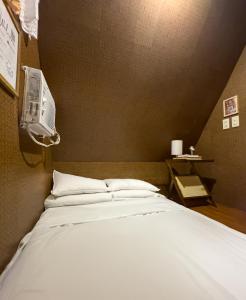 a bedroom with a bed with a air conditioner on the wall at CocoHaus in Batangas City