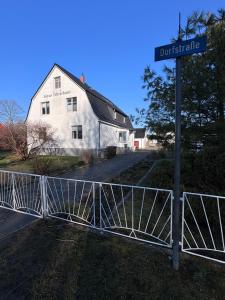 a gate in front of a house with a street sign at Haus Waterkant in Breege