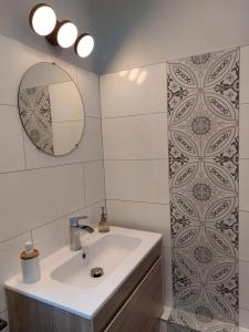 a bathroom with a sink and a mirror at Cocorico in Boué