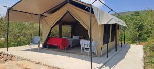 a tent with a table and chairs in it at NATURE LOVERS ADVENTUREs in Maasai Mara National Reserve +23 photos