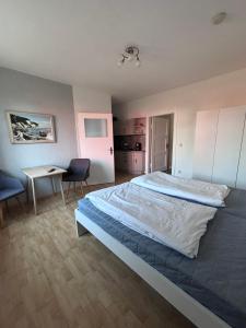 a bedroom with a large bed and a table and chairs at Haus Waterkant in Breege